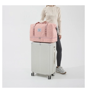 Pink quilted travel bag with star pattern on a suitcase showing luggage handle sleeve