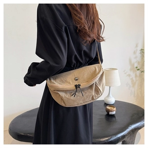 Detail of khaki crescent crossbody bag in washed nylon fabric with double zipper closure