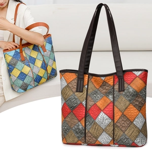 Detail of colorful patchwork tote bag showing animal skin textures and long leather handles