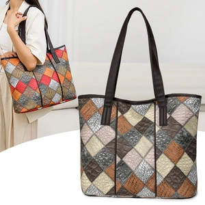 Close-up of patchwork leather tote with crocodile texture and colorful panels