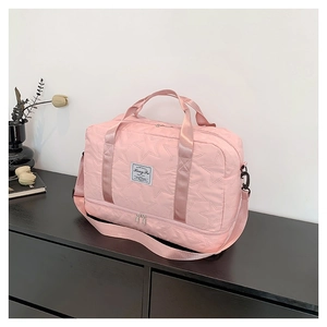 Pink star-embossed fabric travel bag with shoe compartment and adjustable shoulder strap