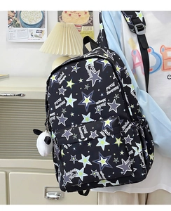 Detail of black nylon backpack with colorful stars and a cute panda plush charm