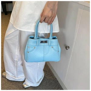 Detailansicht der hellblauen PU-Leder Handtasche mit Lychee-Struktur und silbernem Drehverschluss