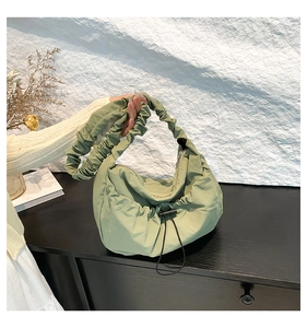 Detail of trendy pleated sage green nylon crossbody bag with drawstring design and strap