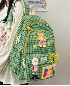 Detail of green houndstooth backpack with cute cartoon bear and star embroidery patches