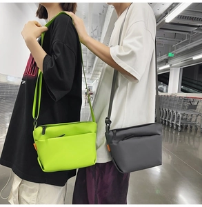 Detail of waterproof nylon crossbody bags in neon green and dark grey with adjustable straps