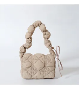Detail view of khaki quilted nylon handbag with ruched cloud handle and side drawstring