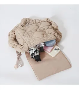 Beige quilted puffer bag interior view showing large storage space for essentials