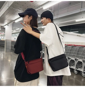 Nylon crossbody bag in black and burgundy with street style design on male and female models