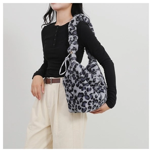 Close-up of fluffy leopard print shoulder bag in grey and black faux fur texture