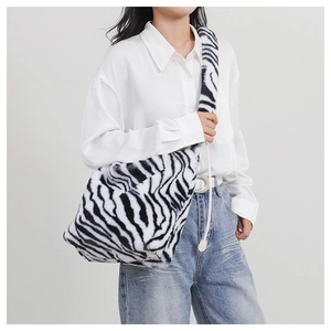 Detail of zebra pattern faux fur texture and matching fuzzy shoulder strap on luxury bag
