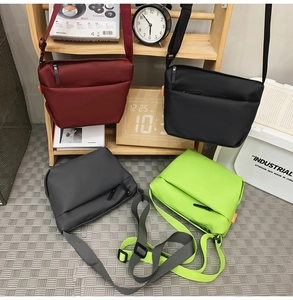 Waterproof shoulder bags in four colors arranged in a modern home lifestyle setting