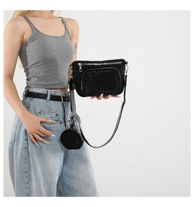 Detail of black rhinestone crossbody bag with round coin purse and striped strap