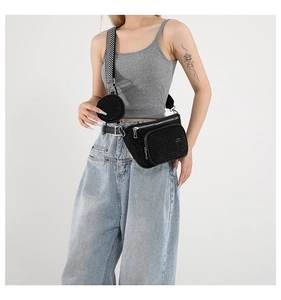 Detail of three-in-one black waist bag with shiny rhinestones and woven shoulder strap