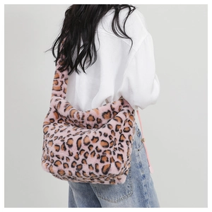 Detailed back view of a pink leopard print plush tote bag worn by a model in casual attire