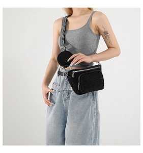 Detail of black rhinestone chest bag with mini pouch and striped woven strap