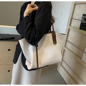 Detail view of large white woven PU leather tote bag with brown straps and large capacity