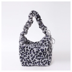 Detailed view of leopard print plush crossbody bag with a stylish ribbon bow and soft handle