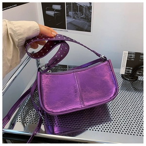 Détail du sac baguette violet métallisé avec bandoulière ornée de rivets argentés