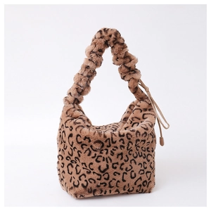 Close-up of leopard print faux fur handbag featuring soft texture and ruched handle