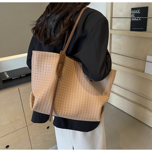 Detail of light brown woven PU leather tote bag showing rich checkered texture and long strap