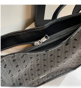 Detail of smooth silver metal zipper and dark gray jacquard fabric texture on a tote bag
