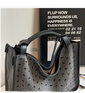 Detailed close-up of herringbone fabric tote bag with black bow patterns and leather handles
