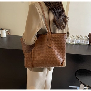 Macro detail of brown woven PU leather tote bag showing intricate texture and capacity