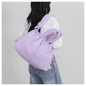 Macro detail of lavender nylon quilted shoulder bag with drawstring closure and knot strap