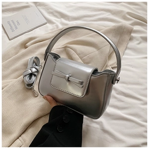 Silver metallic PU leather handbag with decorative bow and detachable shoulder strap