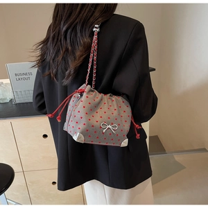 Chic grey knit bucket bag with red heart embroidery and silver bow charm detail