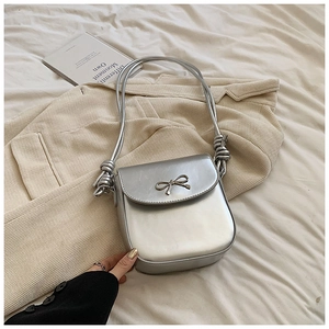 Chic silver PU leather crossbody bag with metal bow pendant and stylish rope strap