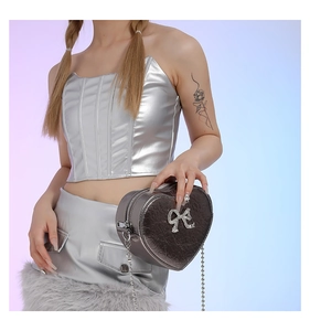 Silver heart-shaped PU crossbody bag with rhinestone bow detail in Y2K style