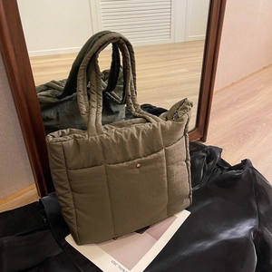 Quilted nylon tote bag in olive green featuring a minimalist square stitched pattern