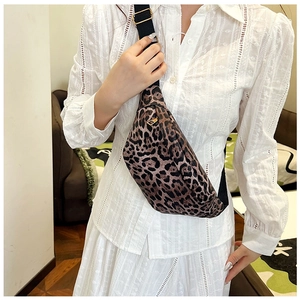 Detailed side view of leopard print crossbody bag with gold zipper and adjustable strap