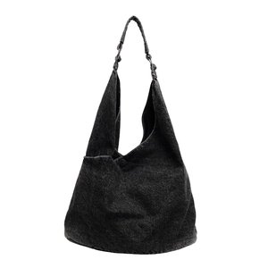 Minimalist dark denim tote bag with woven shoulder straps and vintage washed texture