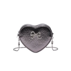 Silver heart-shaped crossbody bag with crinkled PU leather texture and rhinestone bow