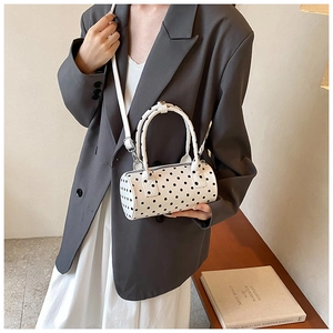 Polka dot cylindrical crossbody bag shown on model for daily casual outfit styling