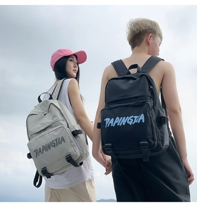 Outdoor shot of stylish nylon backpacks in gray and black with PAPINGJIA logo detail