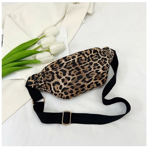 Fashionable leopard print fanny pack with gold hardware on a stylish white fabric background