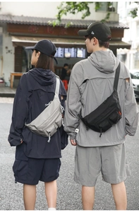Close-up of waterproof nylon waist bag with multiple functional zipper pockets