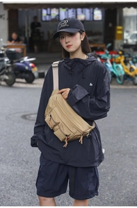 Close-up of khaki nylon utility waist bag with multiple pockets for outdoor urban style