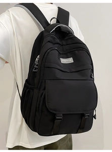 Gros plan du sac à dos en nylon noir avec bretelles en maille respirante et étiquette mode