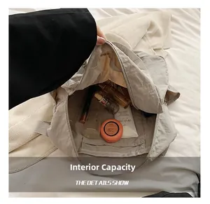 Internal capacity of the nylon shoulder bag showing cosmetics and storage compartments