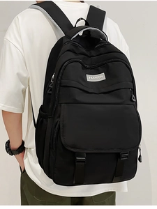 Vue détaillée du sac à dos en nylon noir avec bretelles larges et étiquette de mode