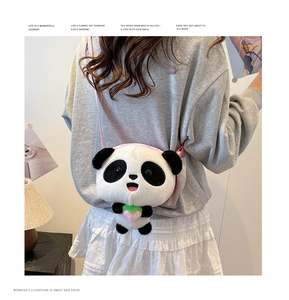 Close-up of a plush panda-shaped crossbody bag featuring a soft texture and pink strawberry detail
