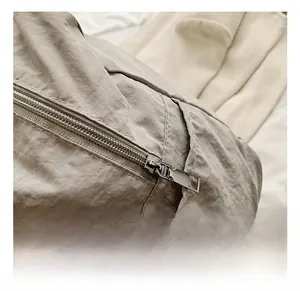 Detailed close-up of nylon fabric texture and premium silver metal zipper hardware