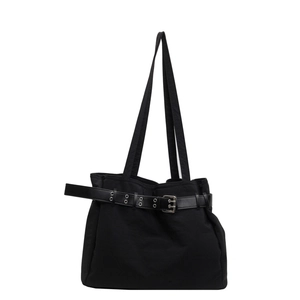 Minimalist black fabric tote bag with leather belt detail and silver metallic eyelets