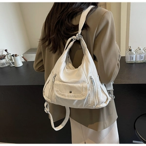 Detailed back view of a white pebble texture PU leather backpack with silver hardware