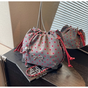 Chic grey fabric bucket bag with red heart embroidery and silver bow detail and chain strap